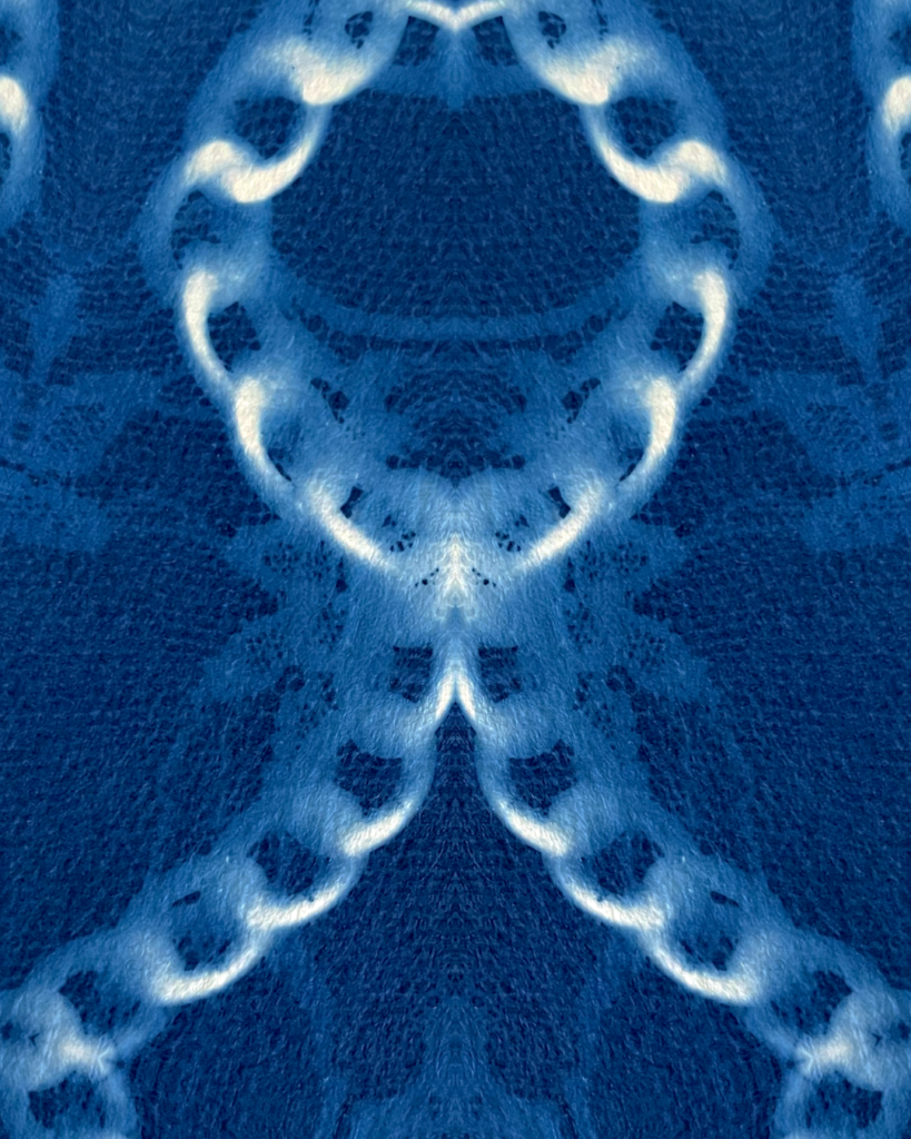 Cyanotype print of chains on lace.