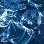 Cyanotype collage featuring varied fabrics, snake skin, plants, and some chains.